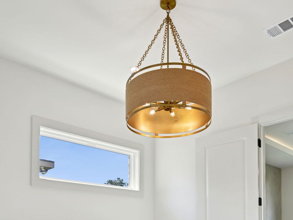 This sophisticated pendant light makes a bold yet balanced statement with its double-drum design. A warm, woven fabric exterior encircles a rich gold interior, casting a soft, golden glow that elevates the ambiance of the room.