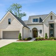 With manicured landscaping, a large two-car garage, and tall windows that allow for natural light throughout, the curb appeal is both charming and sophisticated.