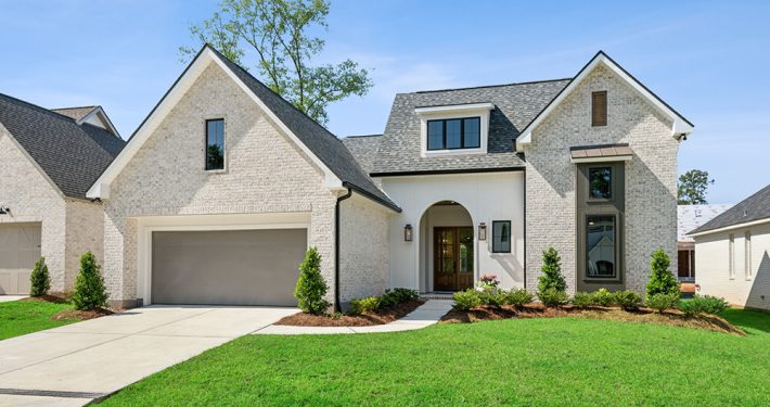 With manicured landscaping, a large two-car garage, and tall windows that allow for natural light throughout, the curb appeal is both charming and sophisticated.