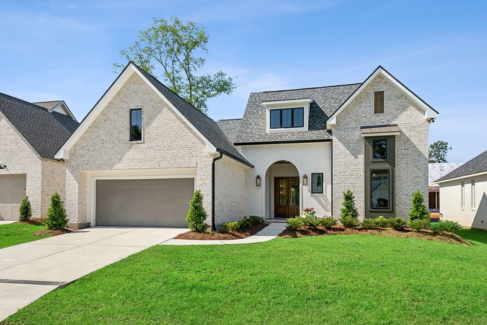 With manicured landscaping, a large two-car garage, and tall windows that allow for natural light throughout, the curb appeal is both charming and sophisticated.