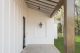 A black-framed glass door suggests a transition from the exterior to the interior space, blending classic and modern design elements.