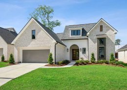 A dormer window above the entry adds charm and natural light to the upper level, while the oversized two-car garage provides ample space and convenience. The home’s thoughtful design balances traditional warmth with contemporary elegance.