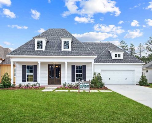 Thoughtful landscaping and a neatly manicured lawn complete the picture, making this home a perfect blend of timeless design and modern comfort.