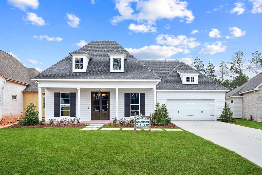 Thoughtful landscaping and a neatly manicured lawn complete the picture, making this home a perfect blend of timeless design and modern comfort.