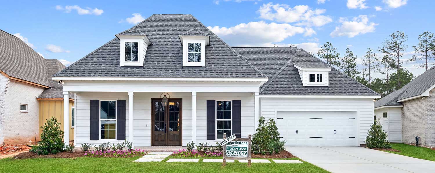 This beautifully crafted custom home combines modern farmhouse charm with timeless craftsmanship. The exterior features a balanced mix of painted brick and vertical white siding, accented by dark shutters and a sleek metal roof above the porch.