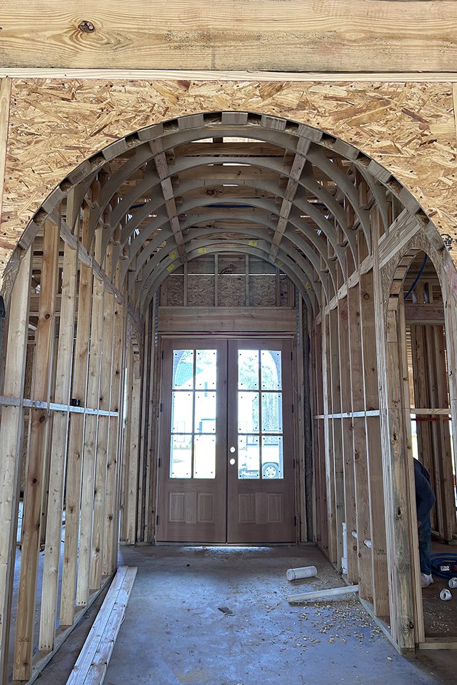 The French front doors allow light to flood the space, setting the tone for the home’s interior.