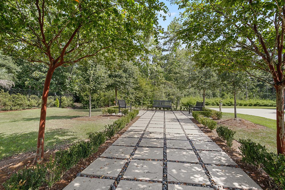 Benches provide a serene spot to relax and enjoy the landscaped surroundings.